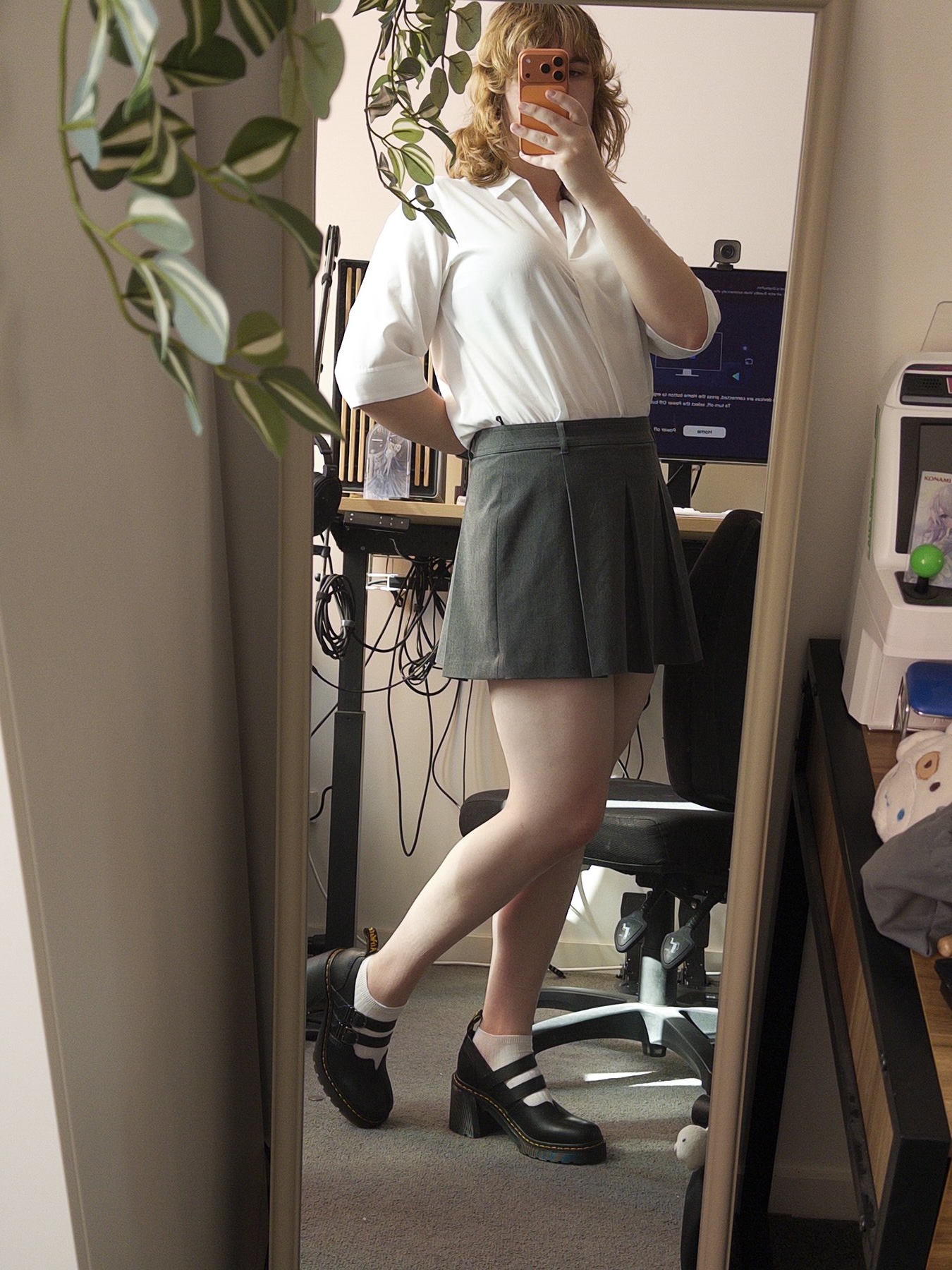 Picture of me in work clothes and new shoes, my desk behind me is messy