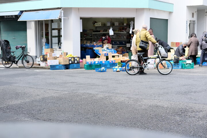 A small grocer with goods spilling onto the street